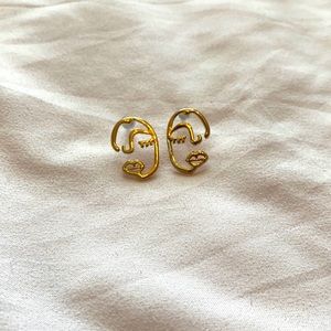 gold half-faced earrings